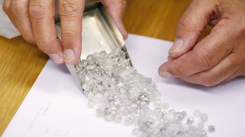 Diamond buyer Elliot Tannenbaum, from the Leo Schachter Diamond Group, looks at uncut diamonds from his company's allocation at a sightholders week at De Beers offices in central London